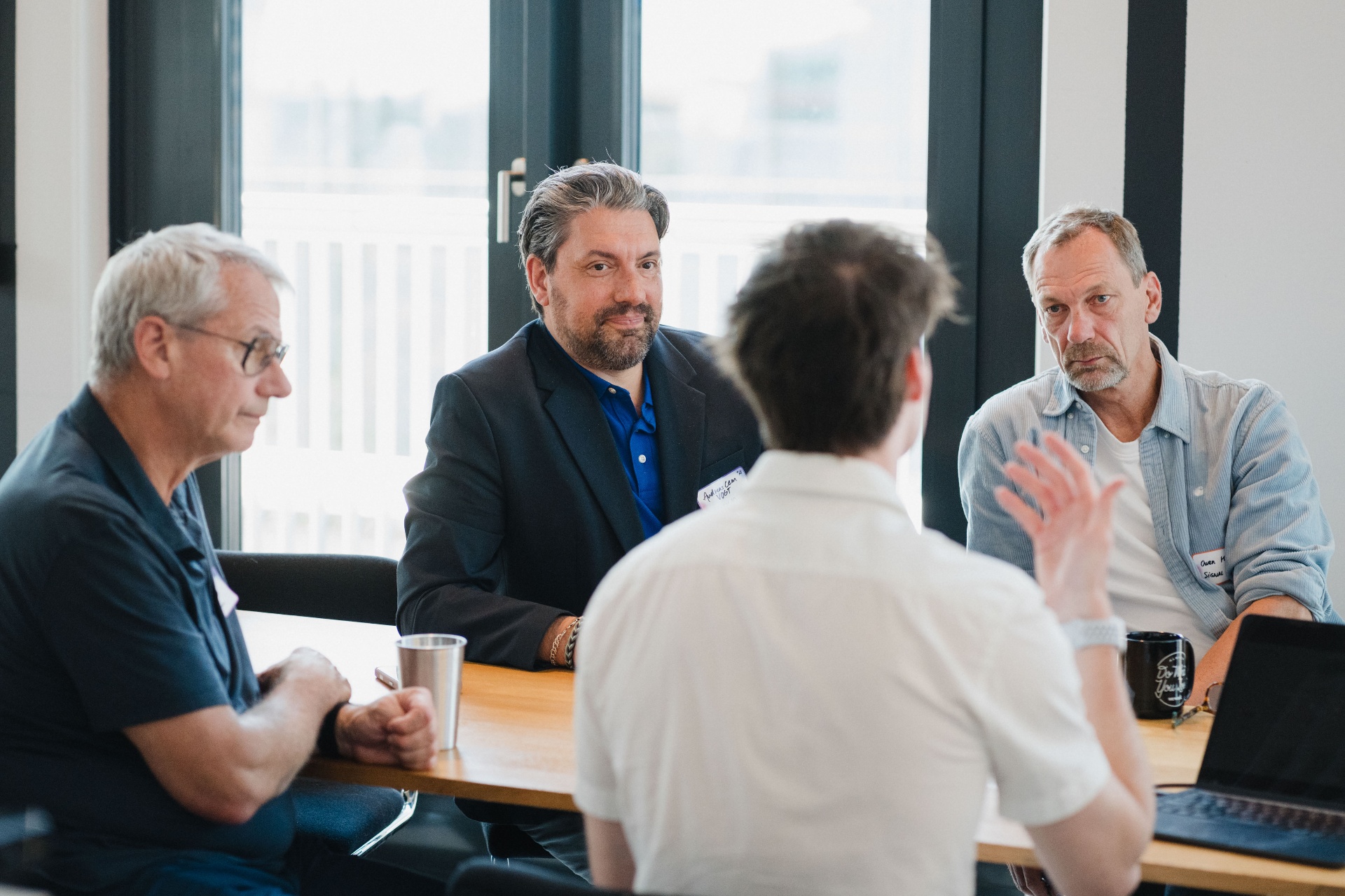 Leaders around a table exchanging ideas